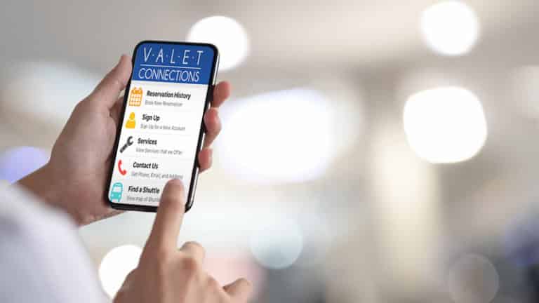 Hand Touching Smart Phone with Valet Connections App on Screen