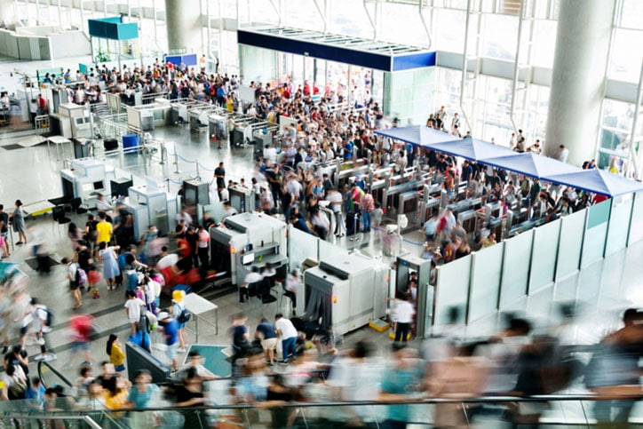 Crowd of people on airport station lobby.