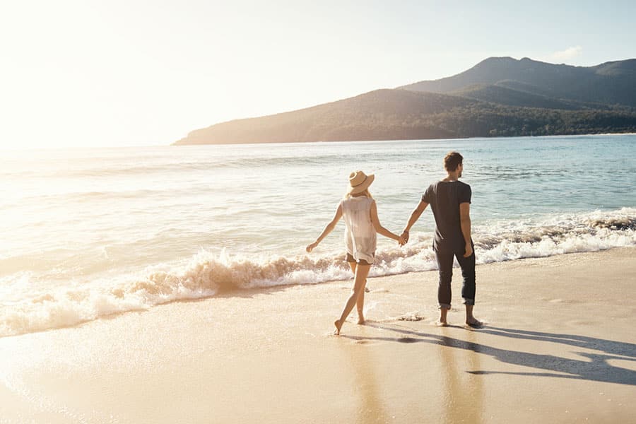 Couple Walking on beach for honeymoon
