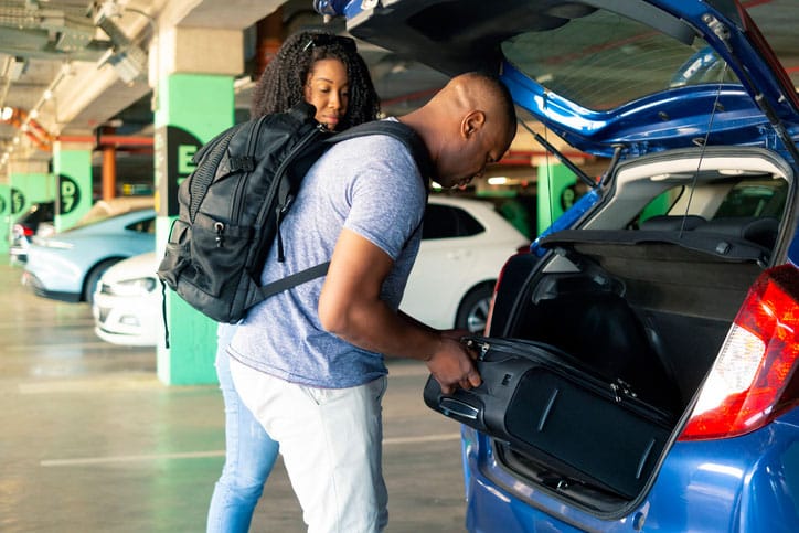 Couple Unloading Their Bags for Offsite Airport Parking in Metro Detroit