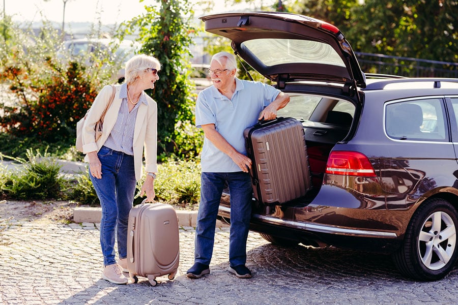 Older Couple Packing Car for Trip